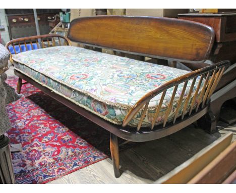 An Ercol three seater studio day bed. Condition - scuff/ding to right arm, otherwise ok, recently replaced webbing, general w