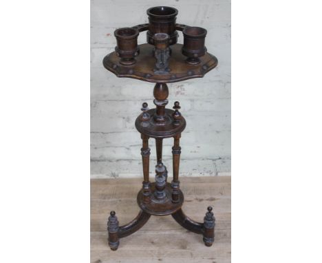 A continental smoker's stand with pipe rack, tobacco mixing bowl and striker on tripod, height 87cm.Condition: top part requi