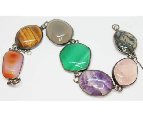 A vintage mixed gemstone bracelet featuring irregular shaped cabochons of quartz varieties cat's eye, moss agate, green bande