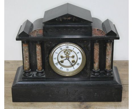 A Victorian black slate and marble mantel clock with visible brocot escapement, length 37cm.  