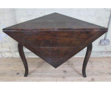 An early 18th century oak gate leg table of triangular form with single drop leaf forming a square, height 69.5cm.  