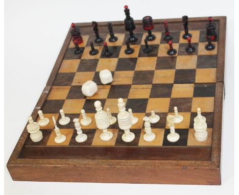 A 19th century bone chess set with fold out chess and backgammon board, kings 9cm in height, together with two ivory dice.Con