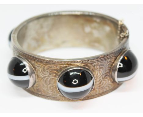 A Victorian Scottish bright cut engraved bangle set with six banded agate cabochons, the cabochons approx. 18mm in diameter e