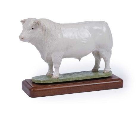 John Harper Shebeg Pottery, Isle of Man: a study of a Charolais bull, on naturalistic base set on wooden plinth, 28cms.