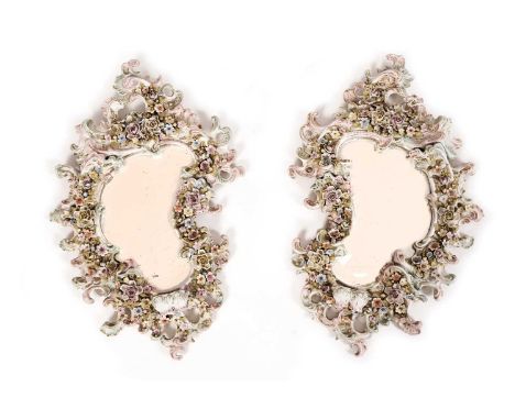 After Dresden: a pair of 19th Century Continental girandole wall mirrors, with floral and foliate decoration and two candlest