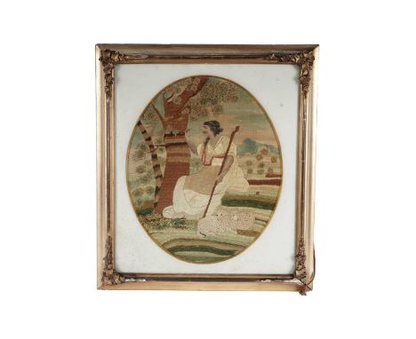 A George III silkwork picture, depicting a shepherdess and her flock, incorporating various specimen needlework, including lo