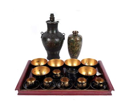 A collection of Chinese and Japanese lacquer bowls and tea wares, the bowls with gilded interiors decorated with fish, the cu