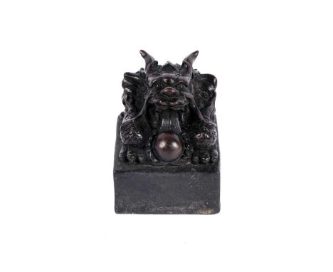 A Chinese bronzed metal ceremonial seal, with dragon and flaming pearl, 13cms high.