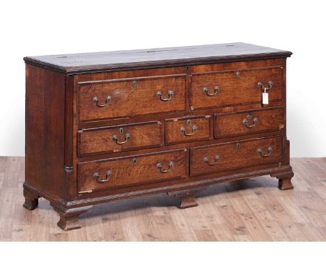 A George III oak and mahogany banded Lancashire mule chest, with moulded rectangular hinged top above two dummy drawers and f