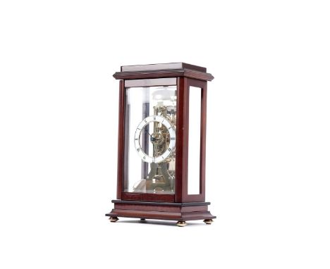 The Greenwich Clock Co: a skeletonised mahogany cased four glass 30-hour mantel clock, with white enamel roman chapter ring, 