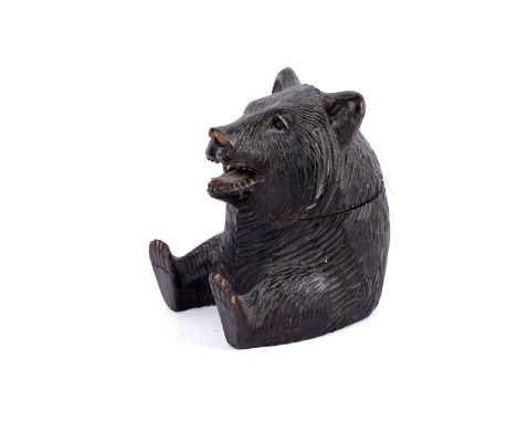 A Black Forest carved inkwell in the form of a bear, circa 1900, no lining, 9cms high.