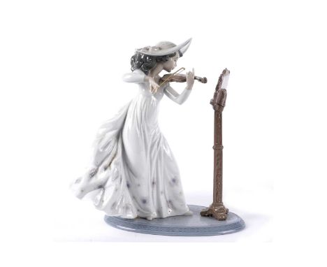 A Lladro ‘Sweet Symphony’ figure, no. 6243, depicting a lady in flowing dress playing the violin, boxed, 24cms high.