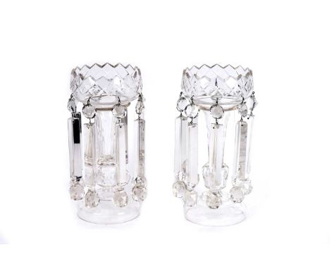 A pair of Victorian cut-glass table lustres, vase-shaped on baluster stems and circular bases, both with eight facet cut drop
