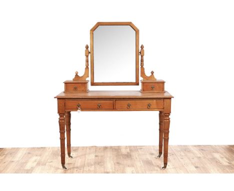 A Victorian ash dressing table, in the aesthetic taste, with swing framed mirror flanked by turned supports and a pair of jew