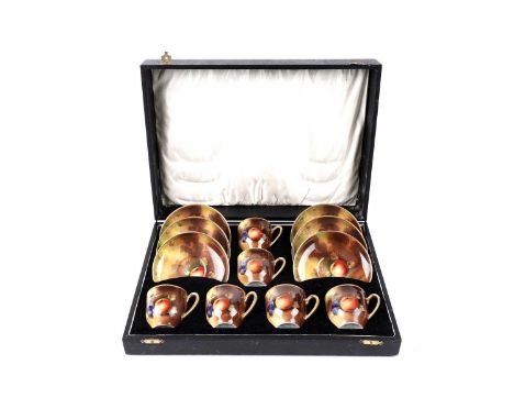 A cased early 20th Century Japanese export hand-painted tea service, decorated with fruit and gilded edges and handles.