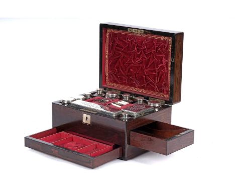 A Victorian rosewood ladies travelling vanity case, the lid with inset mother-of-pearl cartouche, opening to reveal a fitted 