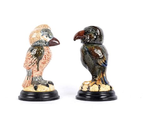 Two Martin Brothers style ‘Wally Bird’ tobacco jars, both sitting on turned circular wooden bases, the tallest 26cms. (2)