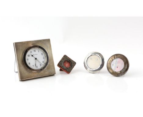 Silver clock by R Carr with shipping interest, 10 cm wide, and three silver photo frames, various dates and makers, (4)