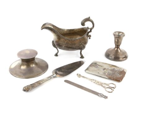 George III silver sauce boat, London 1782, possibly by Hester Bateman, 19 cm long, together with a silver inkwell, dwarf cand
