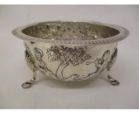 A late Victorian silver bowl by Pairpoint Brothers, London 1900, embossed and chased with a bird in a tree, a boy playing a h