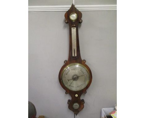 An early 19th century rosewood barometer case with a damp/dry, a thermometer, silvered dial and level, 41"h 