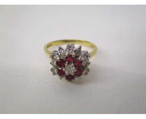 An 18ct gold, diamond and ruby cluster ring set with thirteen diamonds and six rubies, stamped SAJ, size R, 4.2g 