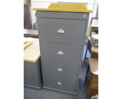 A large modern four drawer filing cabinet 