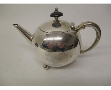 A small Victorian silver bullet shaped teapot by Atkin Brothers, Sheffield 1884 with a straight, tapered spout on three ball 