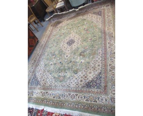 A Persian design carpet with a central medallion, Boteh, flowers and foliage on a green ground, 96" x 130" 
