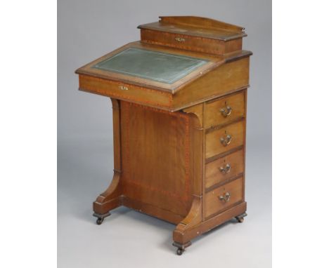 An early 20th century inlaid mahogany davenport, with fitted interiors enclosed by hinged lift panels, gilt-tooled leather wr