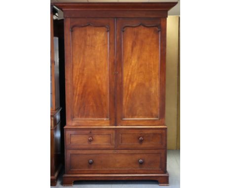 A Victorian mahogany linen press with converted hanging compartment to the upper, enclosed by pair of fielded panel doors, ab