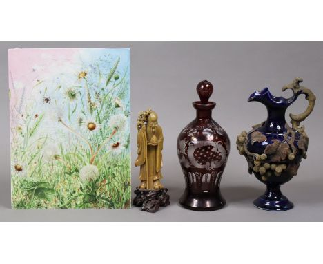 A porcelain rectangular plaque with painted foliate decoration, 30.5cm x 22.75cm; a ruby overlaid decanter; a carved soapston