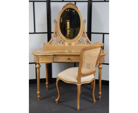 A continental-style light oak inverted breakfront dressing table with an oval swing mirror to the back, fitted three frieze d