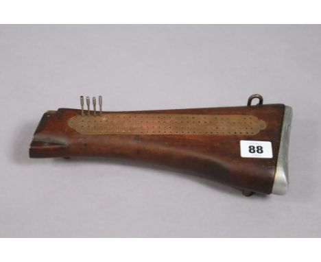 An original gun stock converted to a cribbage board, 27cm long.