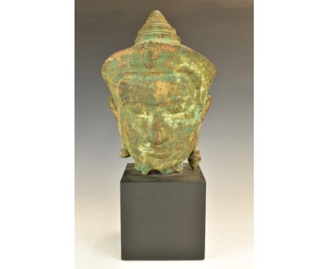 Archaic style cast metal bust on square plinth, possibly Thai or Burmese, height 46cm