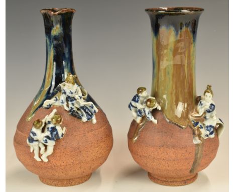 Two Japanese Sumida Gawa pottery pedestal vases with applied figural decoration of children playing hide and seek, height 20.
