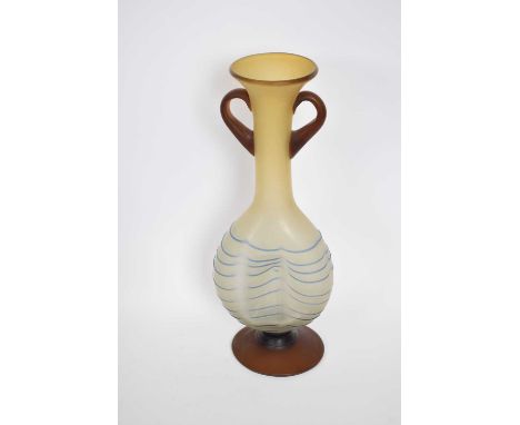 Art glass vase of dimpled shape with loop handles and a trailing blue design, 34cm high