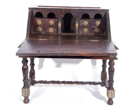 Large 19th century Ceylonese trunk on stand, top section with fall down front containing 8 small drawers, standing on a two-d