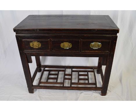 20th century Chinese dark elm three drawer side table with base shelf, 96cm wide