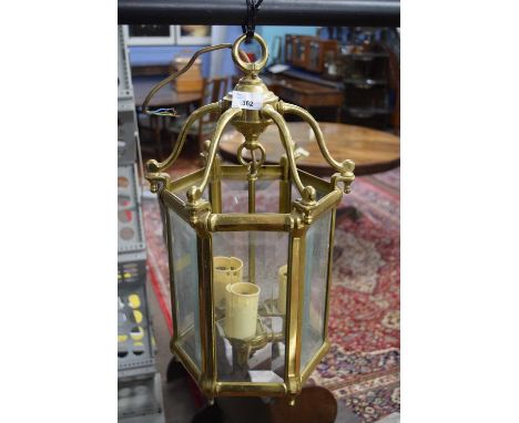 Hexagonal brass and glass mounted lantern light fitting with three internal electric lights, 48cm high max