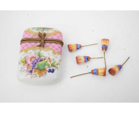 Limoges enamel box decorated with fruit together with four small wooden painted pins