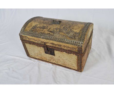 Small 18th/19th century dome top trunk covered in pony skin with metal studded detail, hinged lid opening to a void interior,
