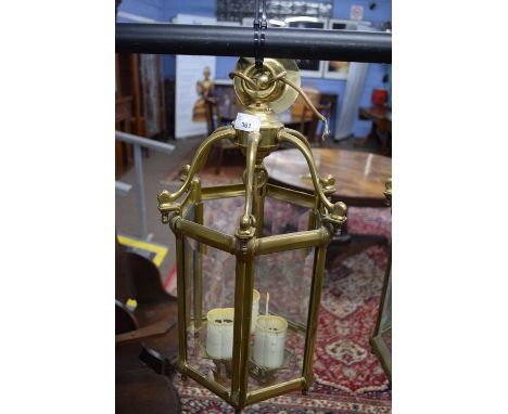Hexagonal brass and glass mounted lantern light fitting with three internal electric lights, 48cm high max