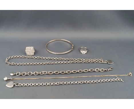 A selection of silver jewellery to include a CZ bangle, two bracelets, two necklaces and two rings. All hallmarked sterling s