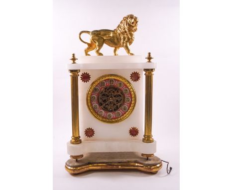 A late 19th century marble mantel clock with visible escapement, the case sporting gilt metal columns, roundels and surmounte