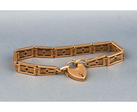 A hallmarked 9 carat gold gate style bracelet with padlock and safety chain. 17.7 grams
