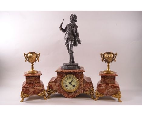 A French rouge marble clock garniture with eight day movement, the clock surmounted by a pewter figure of a boy with a horn, 