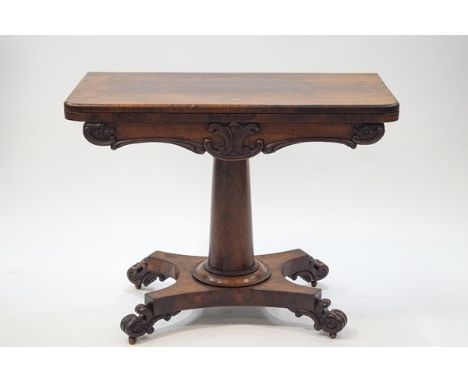 A William IV rosewood card table on tapering cylindrical pedestal on waisted rectangular base with scroll feet and casters, 7
