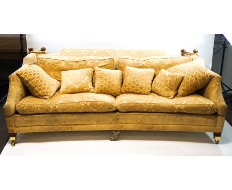 A modern Knowle four seat sofa on square tapering legs with brass casters, gold coloured upholstery, 241cm wide x 85cm high x