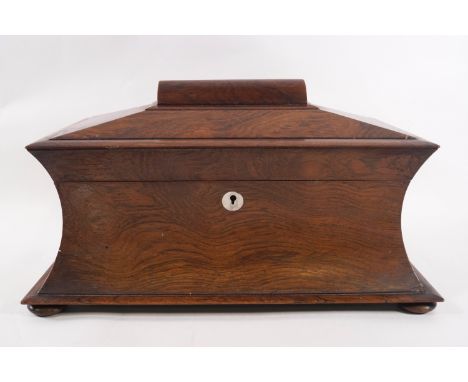 An early Victorian rosewood tea caddy of sarcophagus form with two lidded compartments and later glass dish, 37.5cm wide